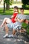 Young couple sitting on bench in park