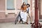 Young couple sitting on a bicycle against the wall