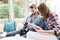 Young couple sitting the coffee shop watching photos