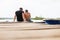 Young couple sitting in dock looking each other at Bocas del Toro Panama