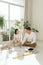 Young couple sitting at floor moving into new home looking at floor plans together