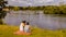 Young Couple Sitting on River Bank