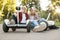 Young couple sitting on road with gyro board