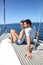 Young couple sitting on sailing boat