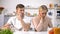 Young couple sitting silently in kitchen after argument, crisis in relationship