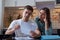 A young couple sitting at a table in the kitchen understands the finances of a young family, studying accounts and tax documents