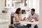 Young couple sitting at the table in their kitchen eating a romantic meal together, selective focus