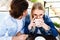 Young couple sitting together at cafe, blond woman drinks coffee