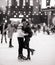 Young couple skates at the rink and embraces