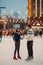 Young couple skates at the rink and holds hands