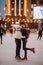 Young couple skates at the rink and kisses