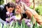 Young couple smelling a purple lilies in a park