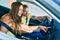 Young couple smiling happy driving car and using gps navigator smartphone