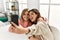 Young couple smiling happy making selfie by the smartphone at home