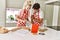 Young couple smiling happy mixing ingredients to make dough for homemade bread