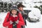 Young couple in snow with car