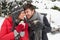 Young couple in snow with car