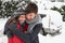 Young couple in snow with car