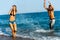 Young couple splashing water at sea side.