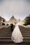 Young couple on the stairs on the background of the architecture of the Bastille Fisherman