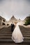 Young couple on the stairs on the background of the architecture of the Bastille Fisherman