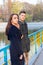 Young Couple Standing on Bridge in Park in Autumn