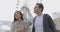 Young couple standing in front of a ferris wheel