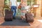 Young couple standing at hotel corridor upon arrival, looking for room, holding suitcases