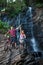 Young couple standing near waterfall with their bikes