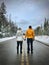 Young couple standing on road holding hands. Newlyweds near Revelstok. British Columbia. Canada.