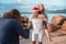 A young couple starred in a video  in Christmas caps on the ocean on a tropical island. Lovers celebrate New Year on the beach and