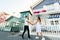 Young couple stays in tango pose and looks each others in Aveiro, Portugal near colourful and peaceful houses. Lifestyle