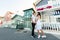 Young couple stays in tango pose and looks each others in Aveiro, Portugal near colourful and peaceful houses. Lifestyle