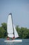 Young couple steering catamaran