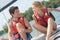 Young couple steering catamaran