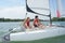 Young couple steering catamaran