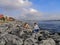 Young couple stroking a homeless cat on the embankment of the Bosphorus in Istanbul Turkey. Man and woman on the stone coast of