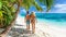 Young couple strolling on pristine white sand beach on a tropical paradise island