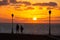 A young couple strolling at sunrise on the coast, Caleta de Fuste, Fuerteventura, Canary Islands, Spain