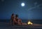 Young couple on summer beach at night