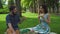 Young couple in summer picnic park to eat sandwiches, enjoying the flavor and smiling.