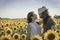 Young couple at sunflowers field