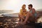 Young couple of surfers is chatting and enjoying romantic moments while camping at the beach at sea together. Summer, vacation,