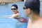 Young couple swimmers preparing to race at the swimming pool