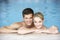 Young Couple Swimming In Pool