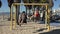 Young couple on a swing set at a beach playground