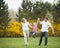 Young couple swinging daughter between them