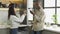 Young couple takes clean glasses out of dishwasher in kitchen