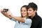 Young couple taking auto portrait with camera.