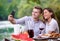 Young couple taking selfie on french dinner party outdoor